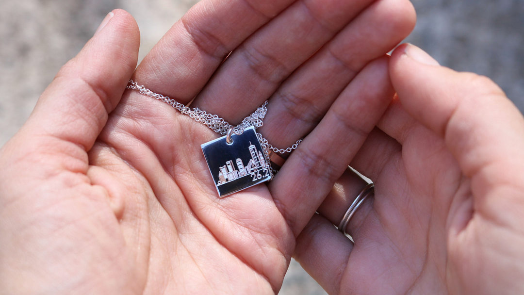 hands holding a custom-engraved necklace