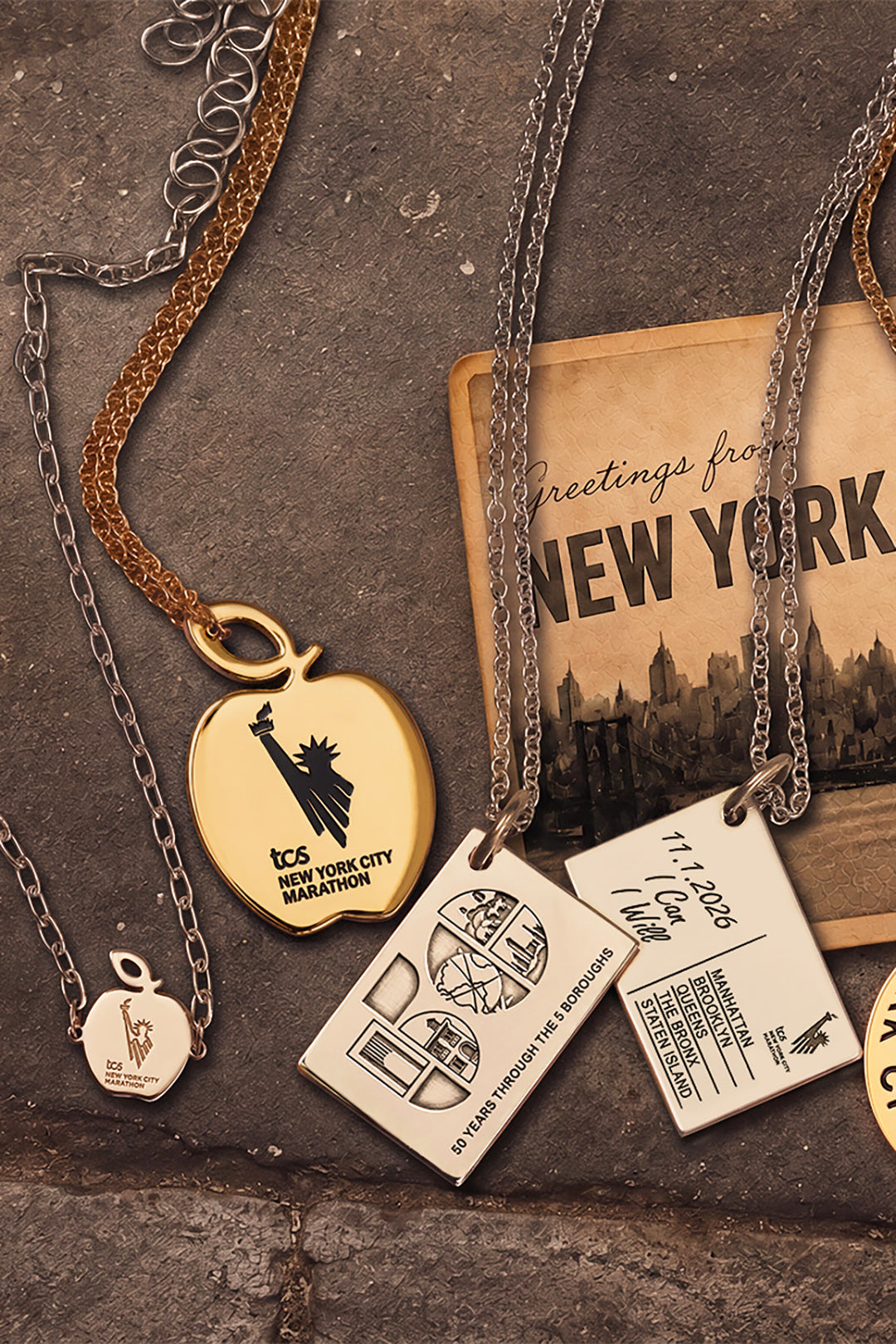 Sterling silver and gold jewelry from the official TCS New York City Marathon collection, including the five boroughs postcard necklace