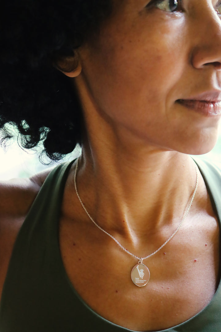 woman wearing a TCS New York City Marathon necklace